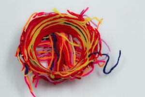 red and yellow yarn in a bowl shape