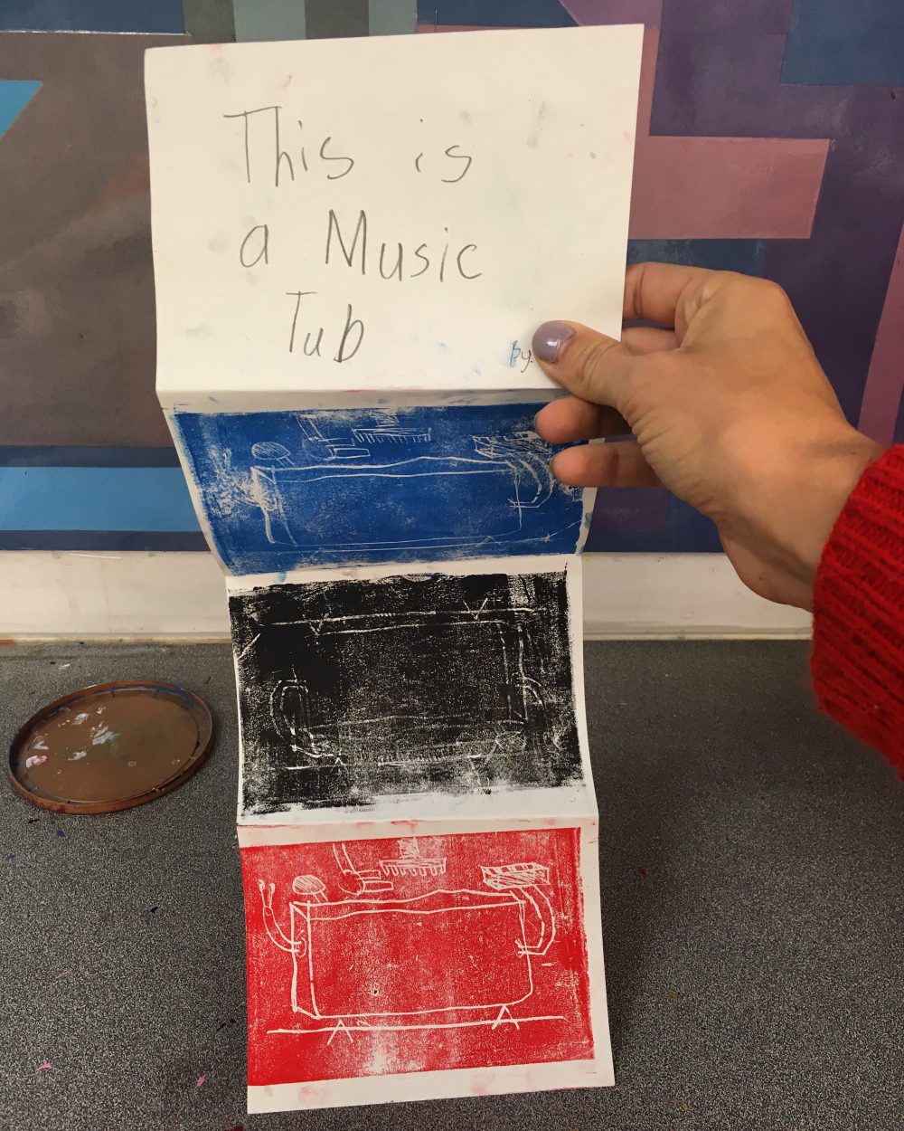 fold book "this is a tub" with blue, black, and red prints