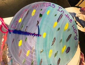 blue and purple disc with writing "everyone matters in the world"