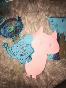 cutout drawings of a monster and cat