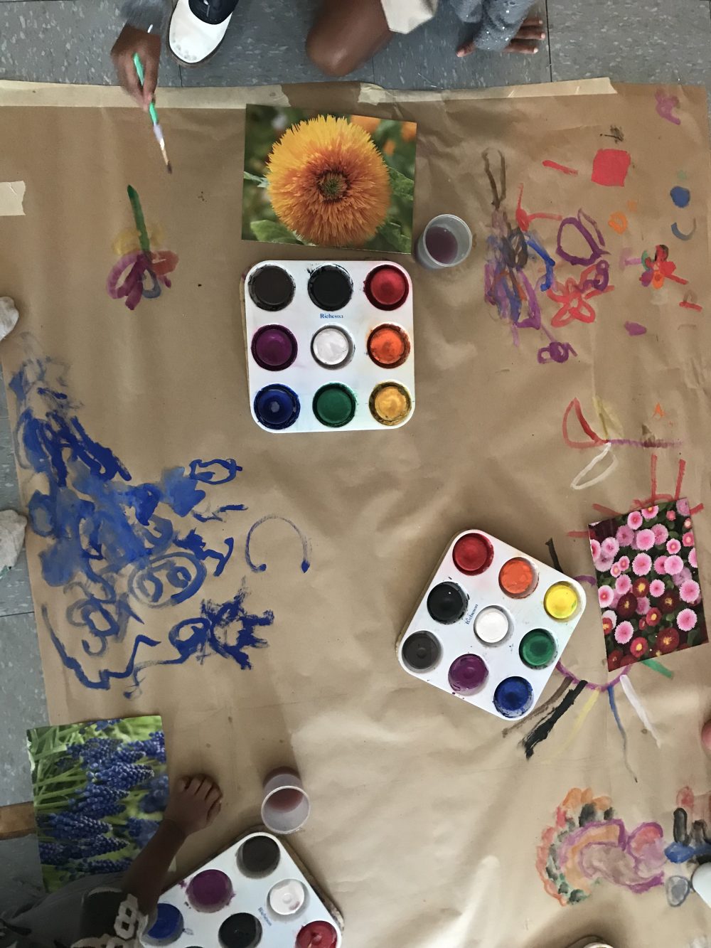 colored paints with painting on brown paper
