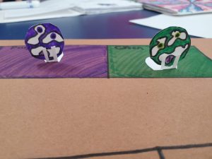 purple and green board game pieces