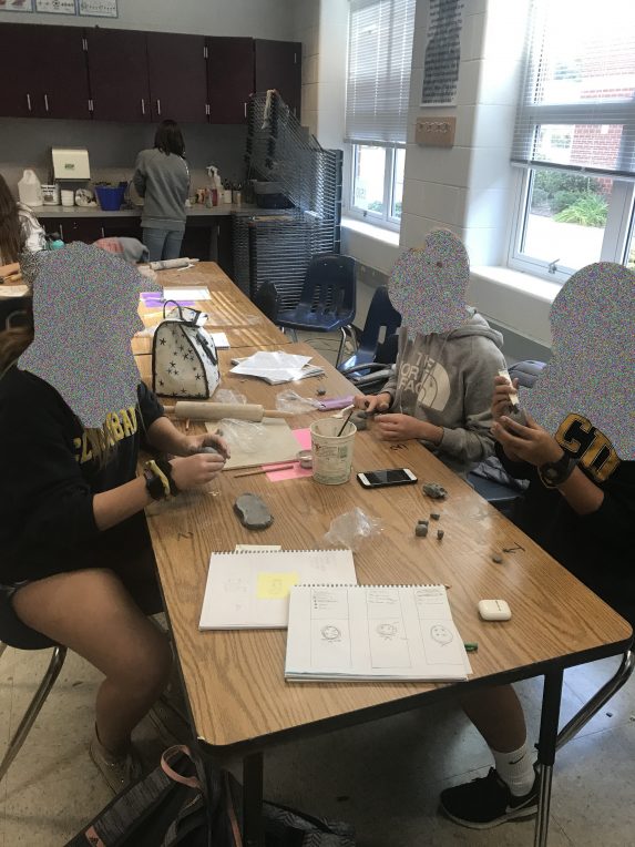 students working with clay