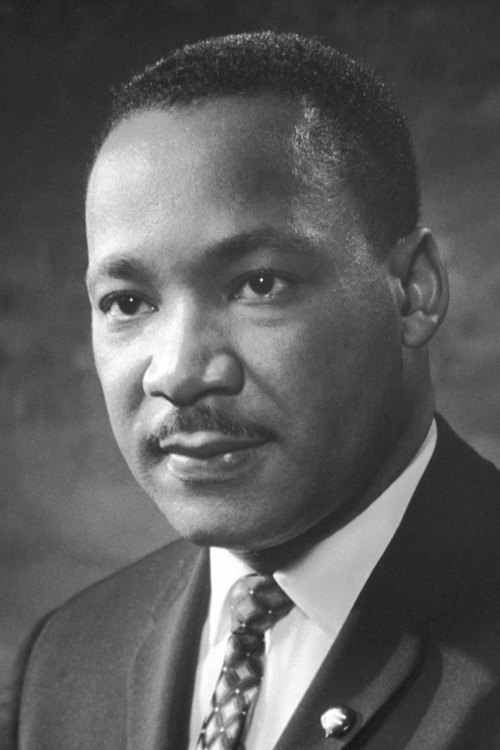 Black and white photograph of Martin Luther King, Jr. Nobel Foundation, Public domain, 1964.