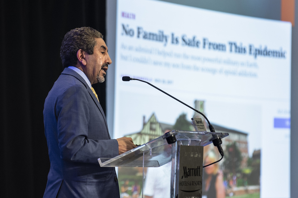 Omar Abubaker speaking at a symposium in March 2019
