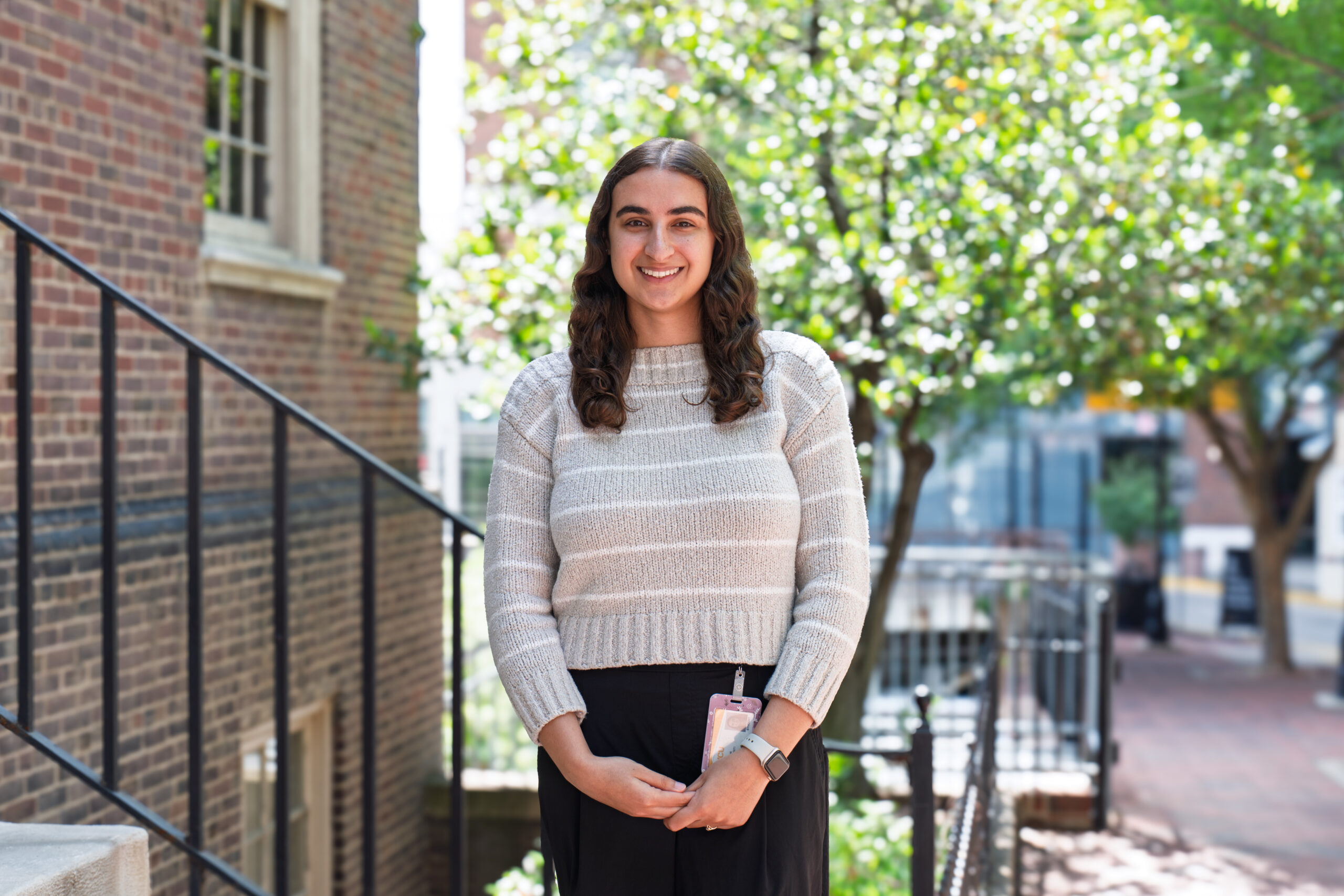 Nina Dashti-Gibson standing outside with trees in the background.