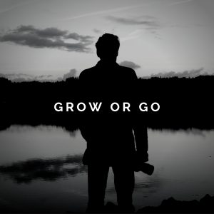 A man looks out over the horizon of a lake with the words "Grow or Go" in the center of the image.