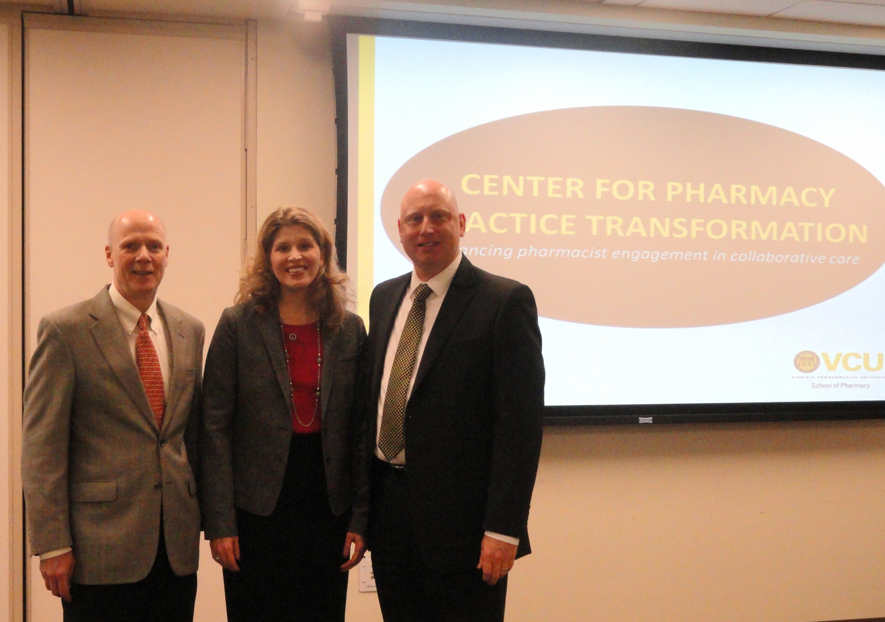 Three VCU faculty members standing in front of a PowerPoint slide that reads "Center for Pharmacy Practice Innovation"