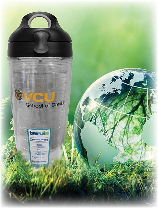 Image of a water bottle next to a decorative globe in green grass. 