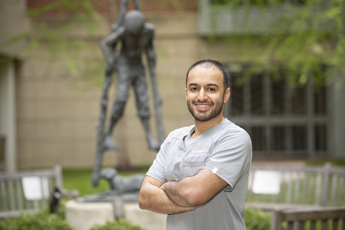 Image of Abdullah Alawadhi standing in the courtyard of VCU School of Dentistry.