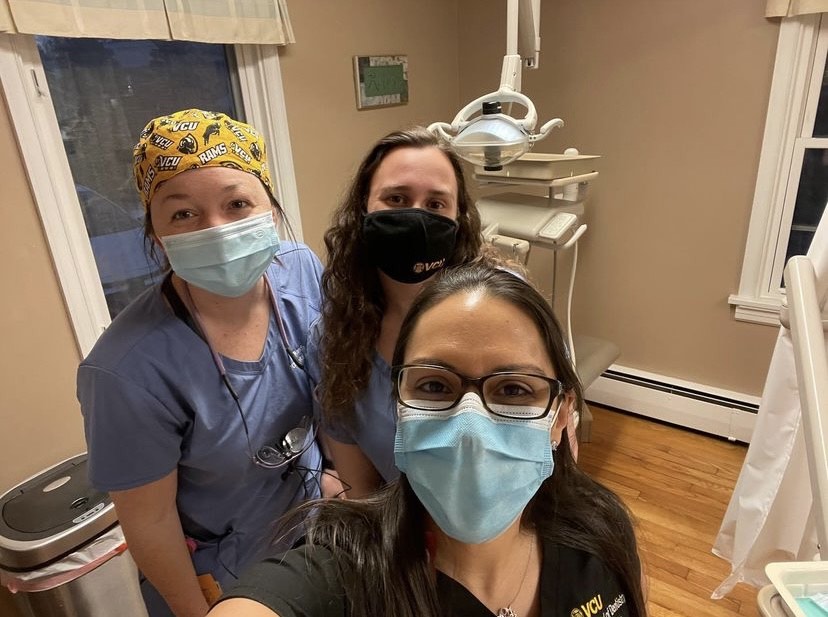 Image of Samantha Smith and two of her classmates in a dental clinic. 