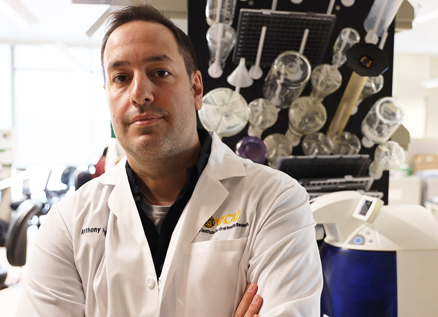 Anthony Faber, Ph.D., associate professor at VCU School of Dentistry, stands with his arms crossed in his laboratory at VCU School of Dentistry