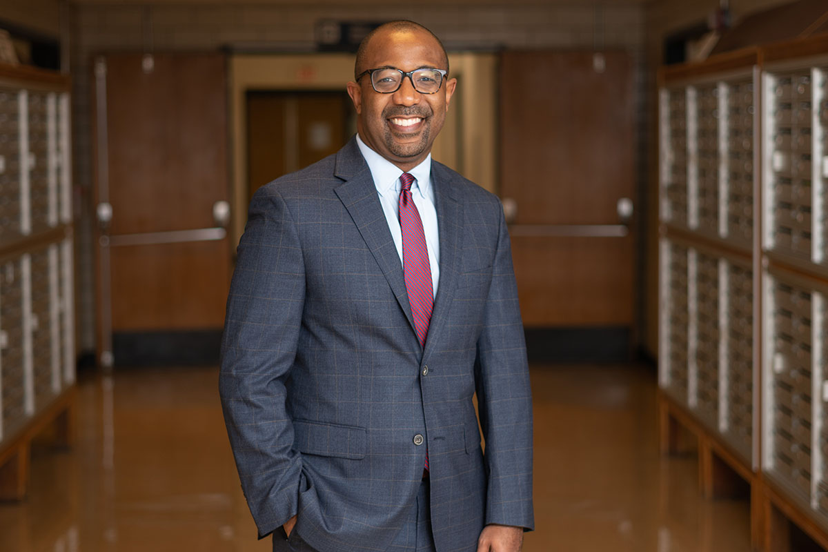 Photo of Dr. Carlos Smith standing in the halls of VCU School of Dentistry