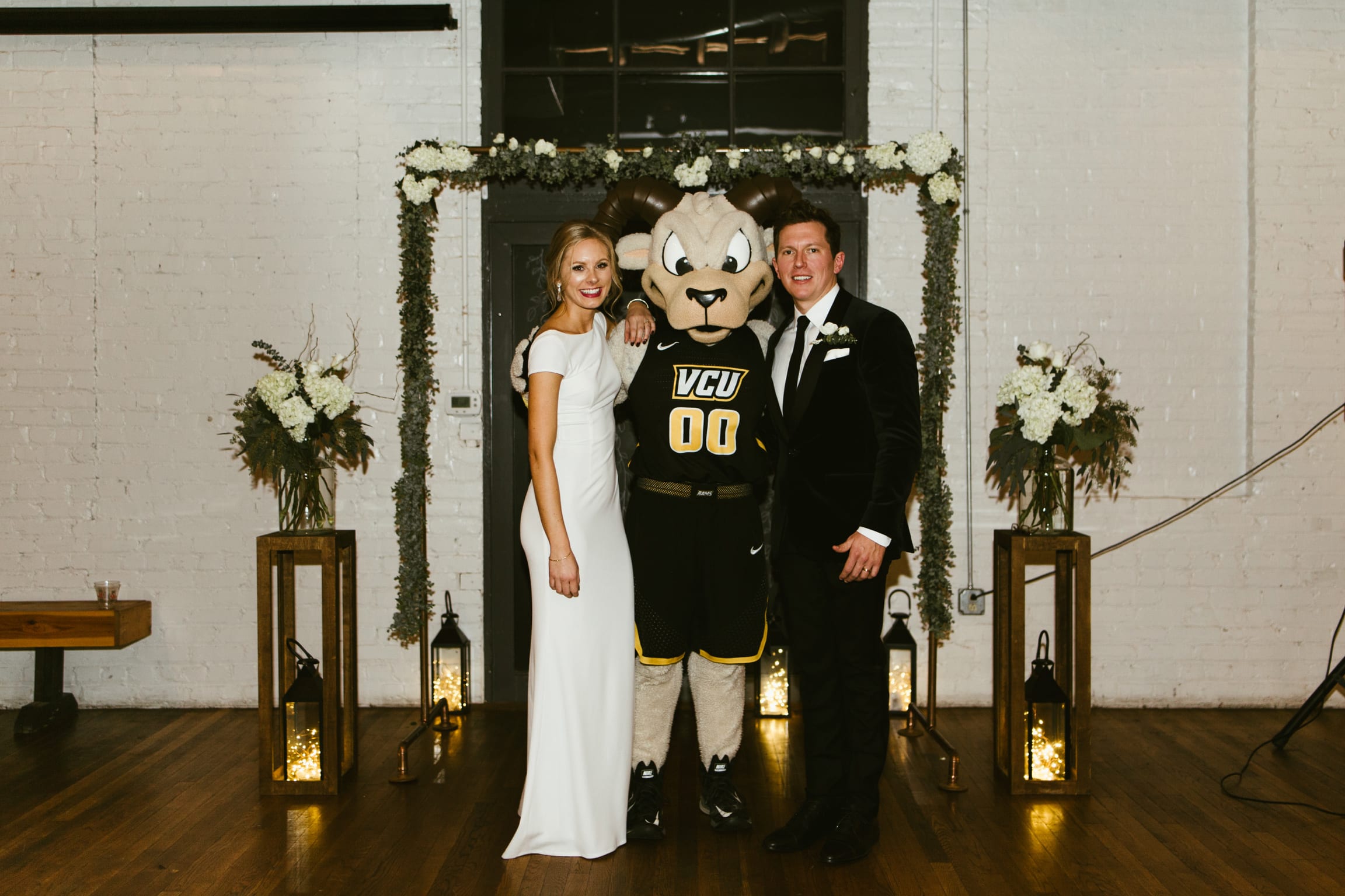 Danielle Hiser and her husband pose with V-C-U mascot Rodney the Ram at their wedding.