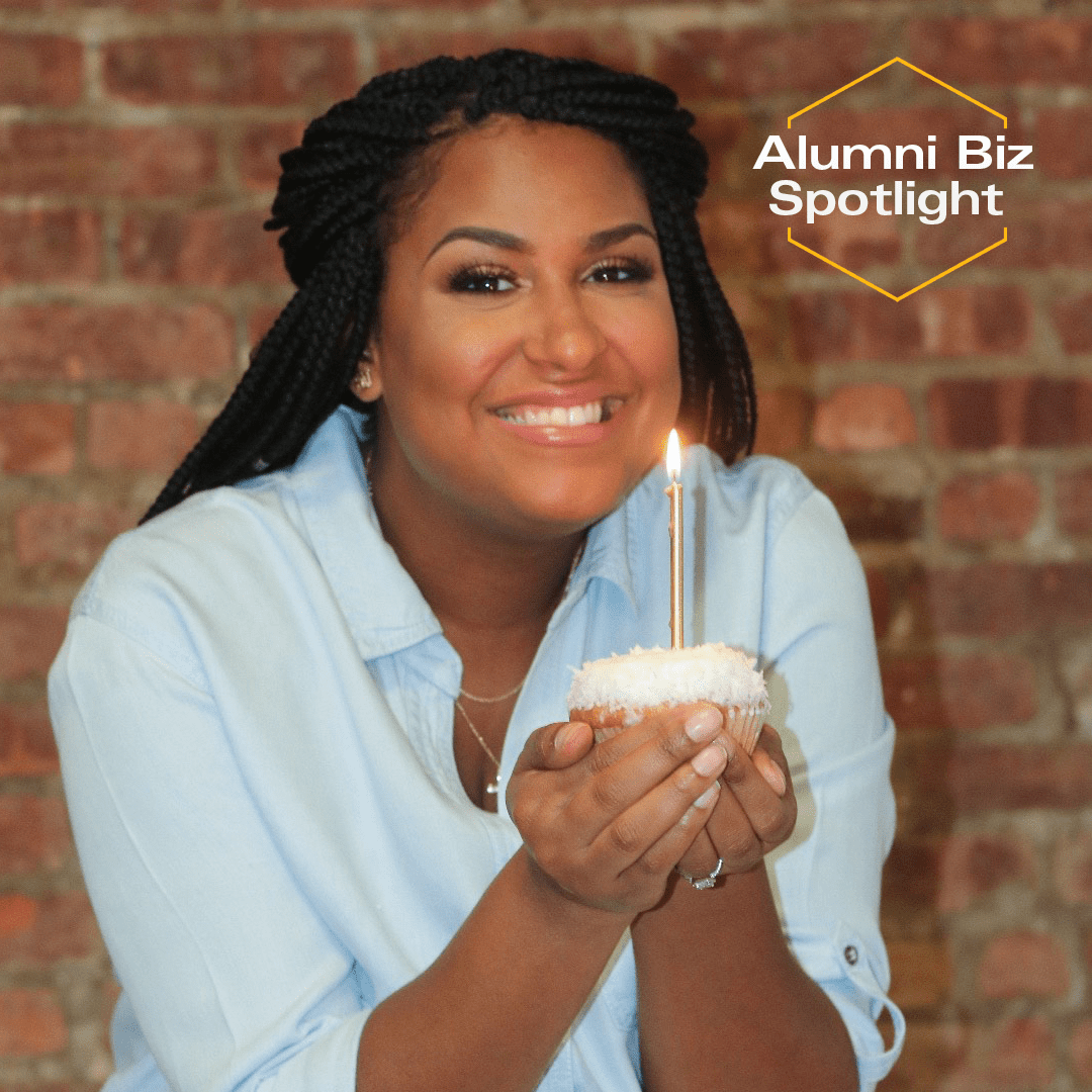 Janice Choudhury holding a cupcake with a lit candle on top.