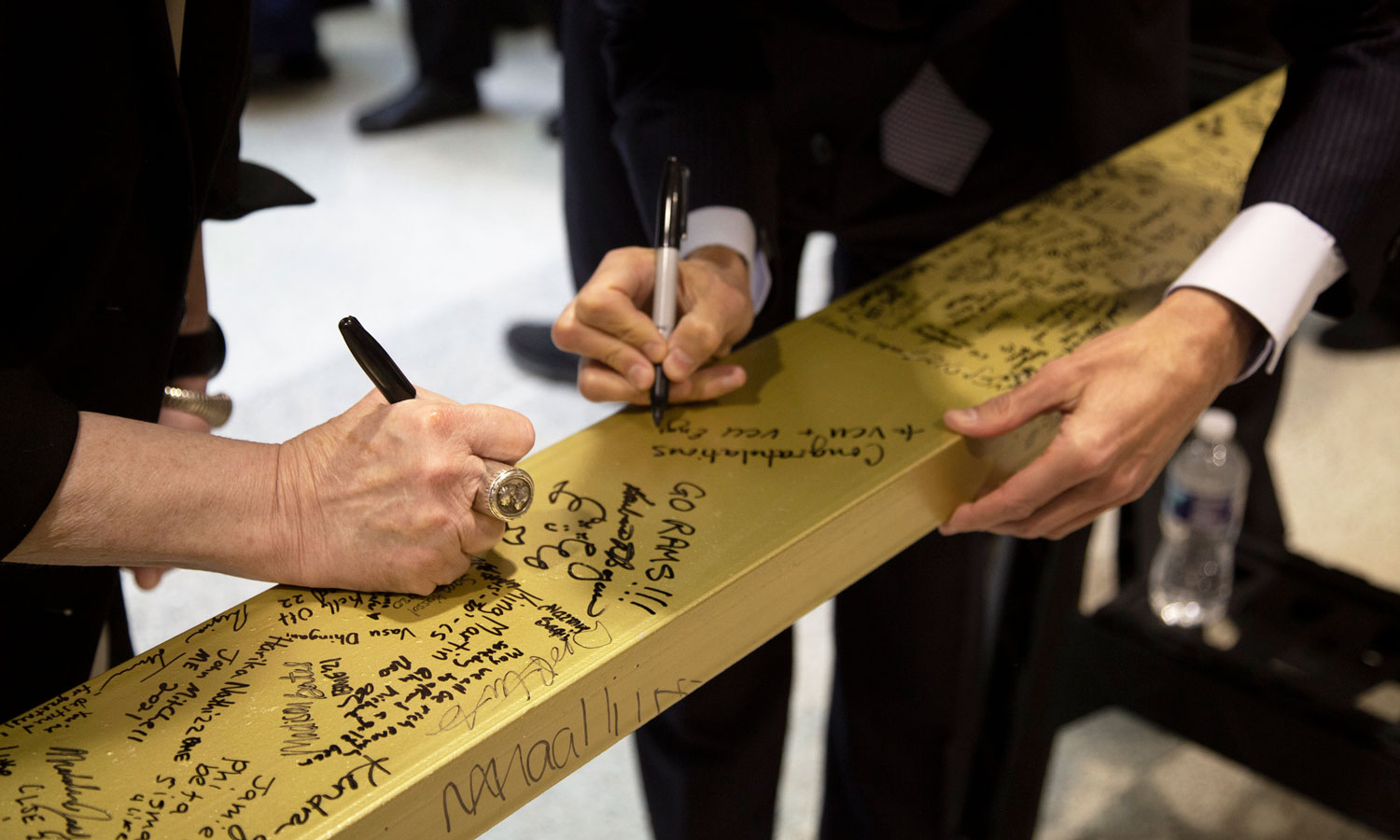 Faculty members signing the final beam for the Engineering Research Building