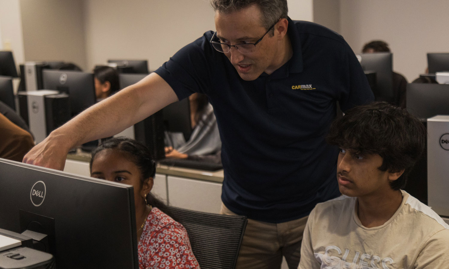 Student participating in a virtual escape room challenge with the help of an instructor