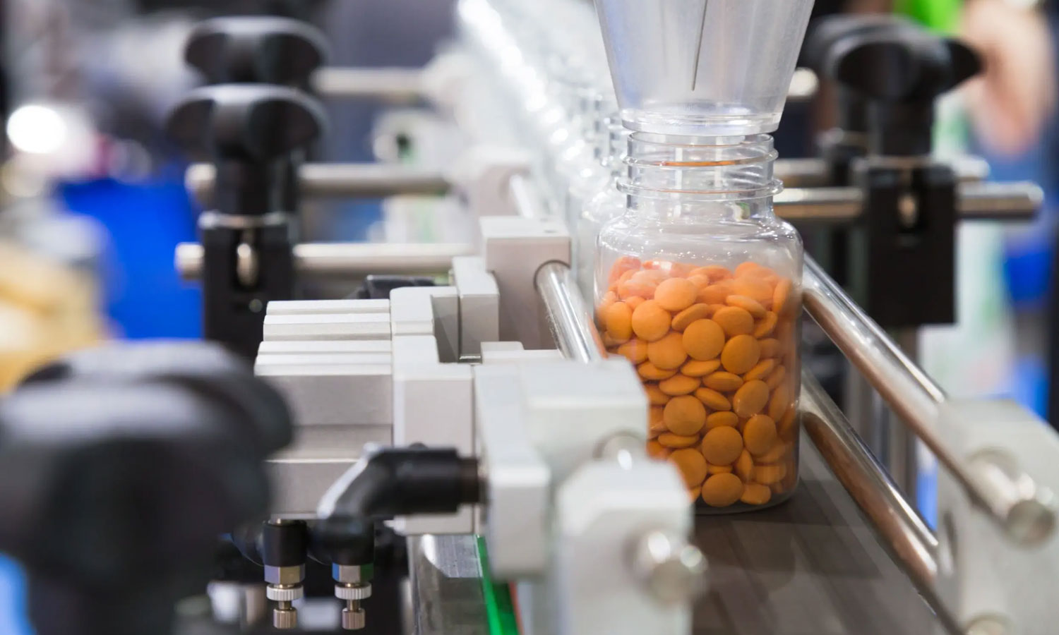 A bottle of medicine being filled in an assembly line