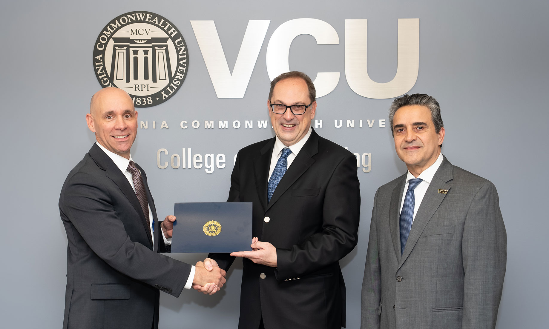 Milos Manic, Ph.D., computer science professor, (center) with Stanley M. Meador, special agent in charge of the FBI Richmond Field Office, (left) and Azim Eskandarian, D.Sc., the Alice T. and William H. Goodwin Jr. Dean of the VCU College of Engineering (right).