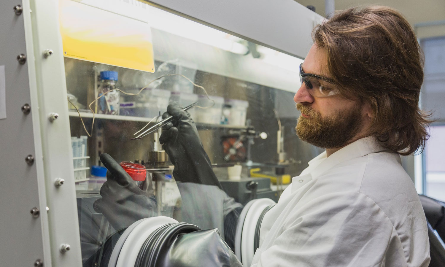 Graduate student prepares a depleted uranium salt ingot for a corrosion study sponsored by the DOE-NE. (Photo by Dan Wagner, VCU Engineering.)