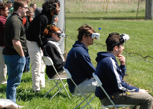 Students focusing as they pilot their drone through the course. 