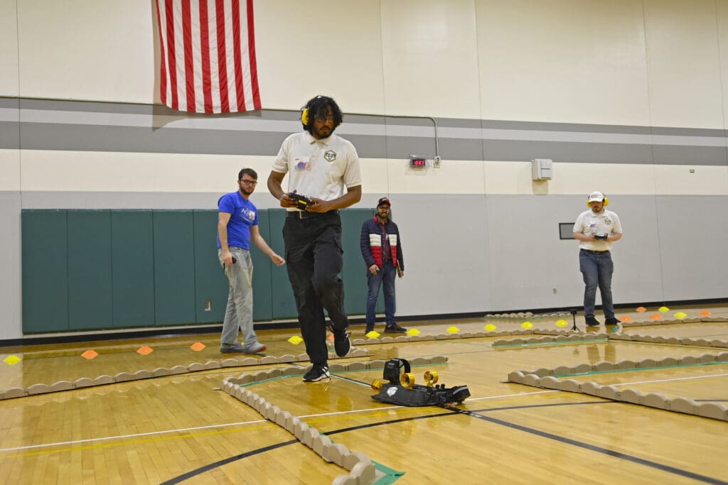 Ishaan Thakur maneuvering Egg Rice through the ground course, with TJ Tuttle supporting the payload. 