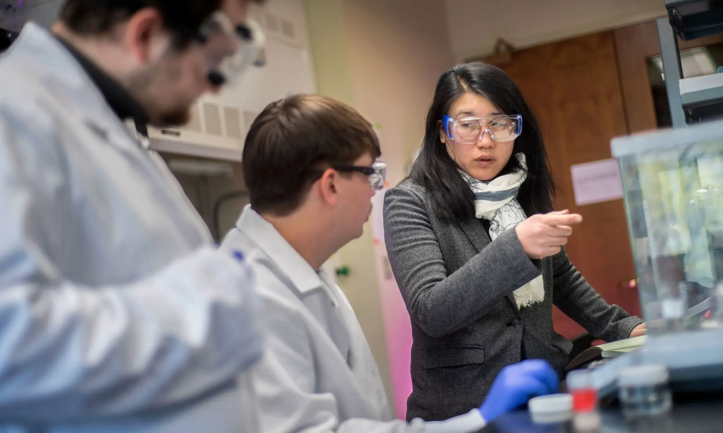Christina Tang, Ph.D., an associate professor in the College of Engineering, with students Matthew Monger (left) and Brandon Hall (center), is researching how fabrics can incorporate materials and sensors that serve biomedical or other purposes.