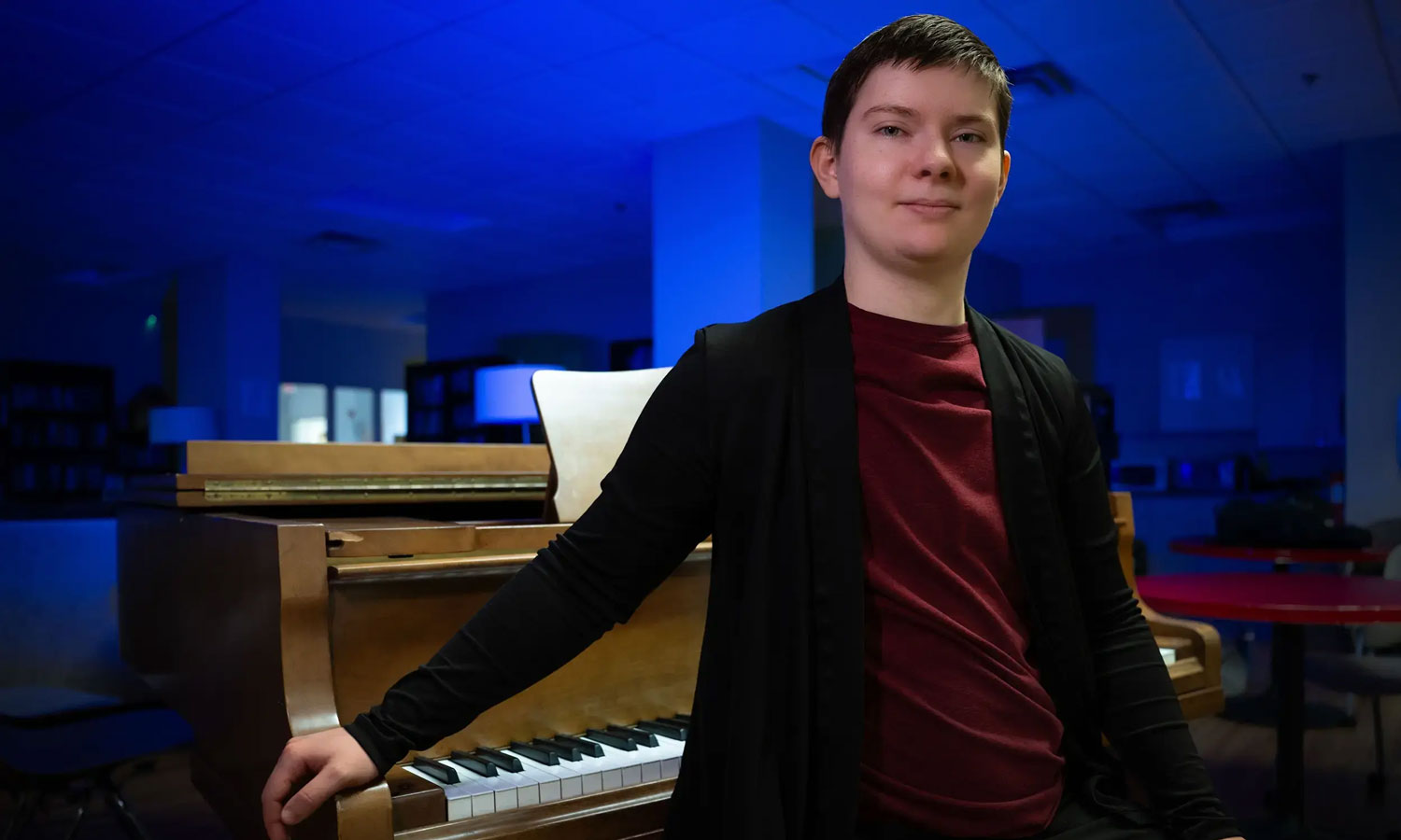 Kel Raphael, here at the piano in the Honors College lounge, has embraced the opportunity to pursue very different academic interests at VCU.