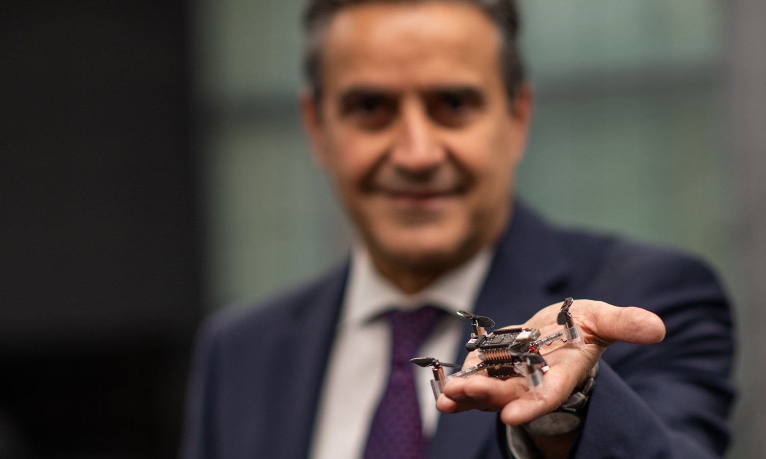 Dean Azim Eskandarian, VCU College of Engineering holds a small drone in his extended hand