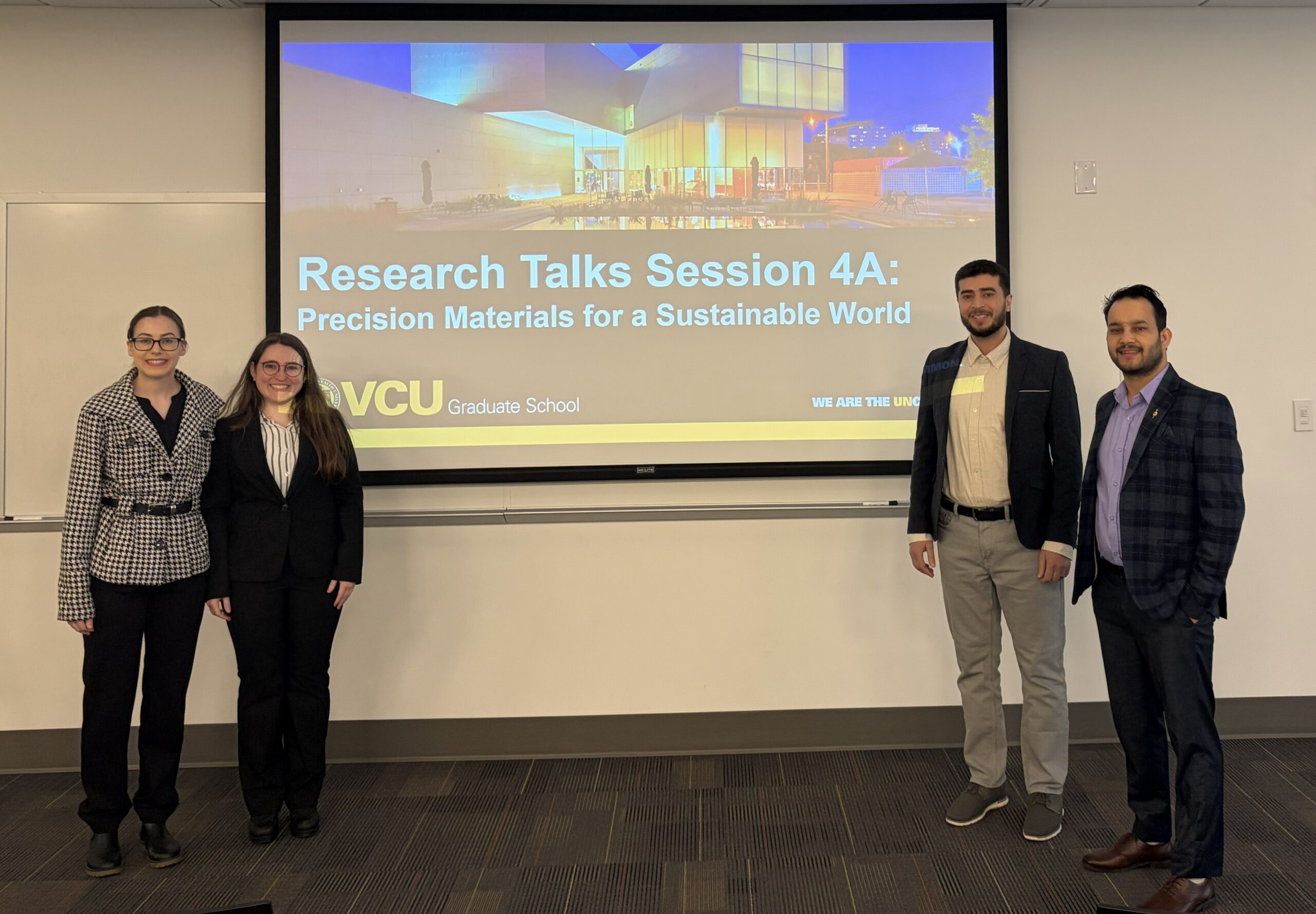 Students standing in front of the room presenting their research.