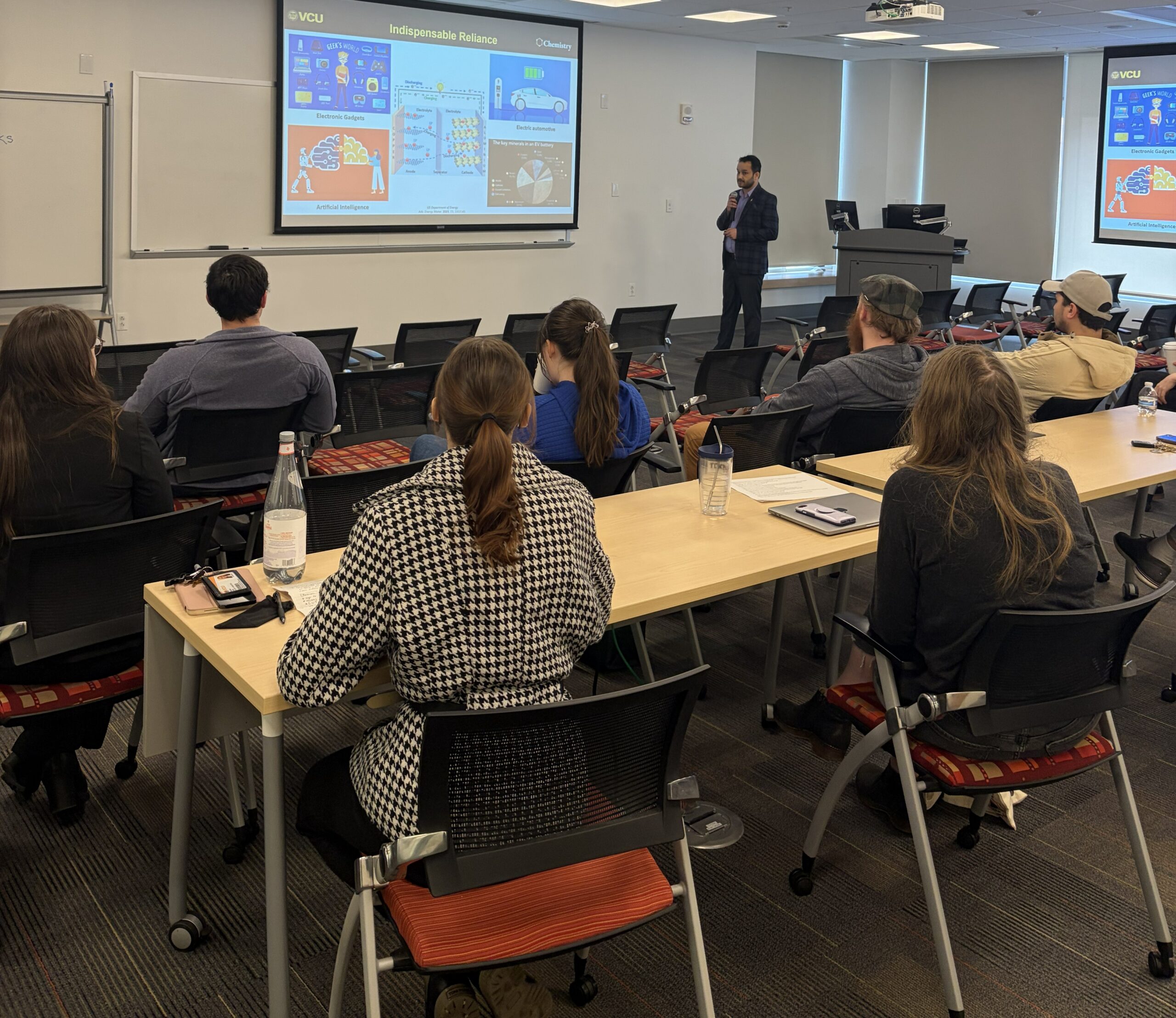 Students sitting in a classroom listening to a presentation.