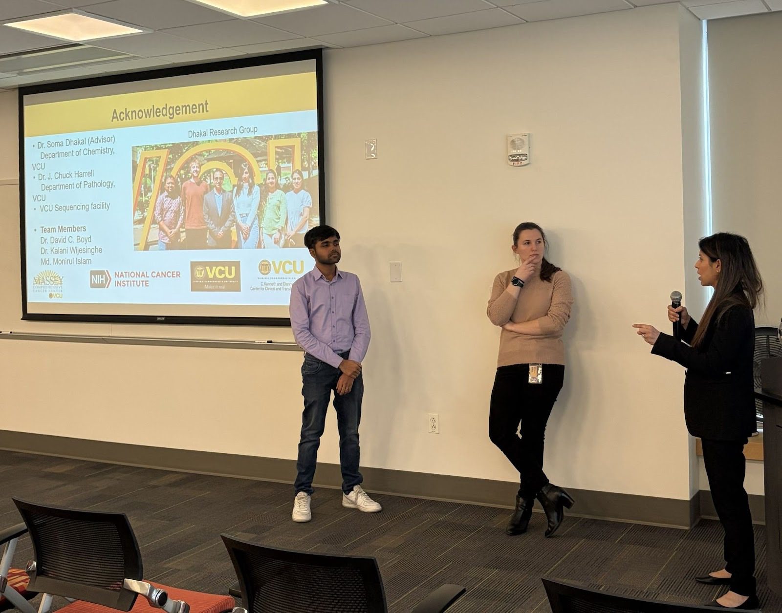 Students presenting their research to a group of people.
