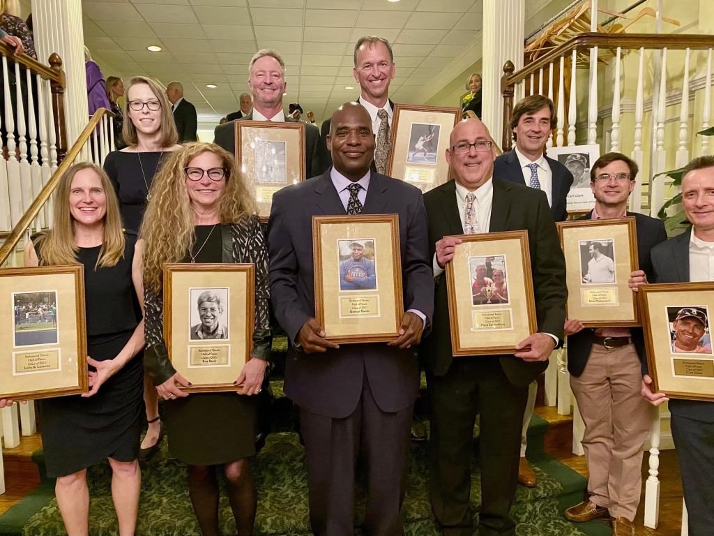 The 2021 RTA Hall of Fame cohort poses with their framed awards on a set of stairs.