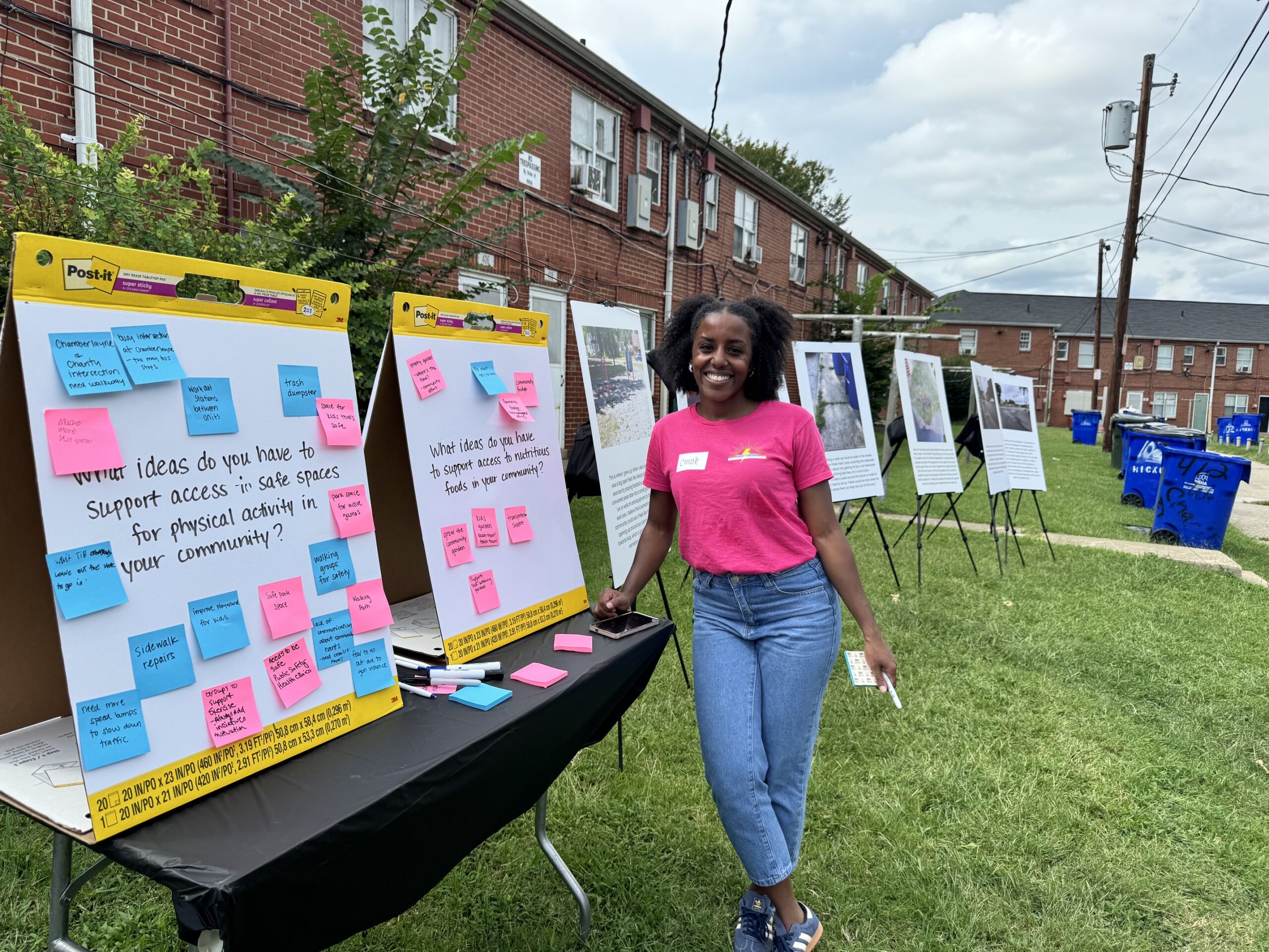 Image of a person standing next to two posterboards