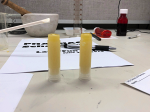 Two tubes of lip balm on a table