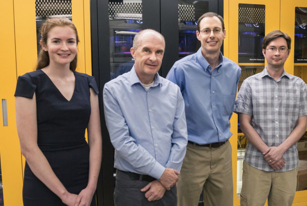 Four researchers stand in a line. 