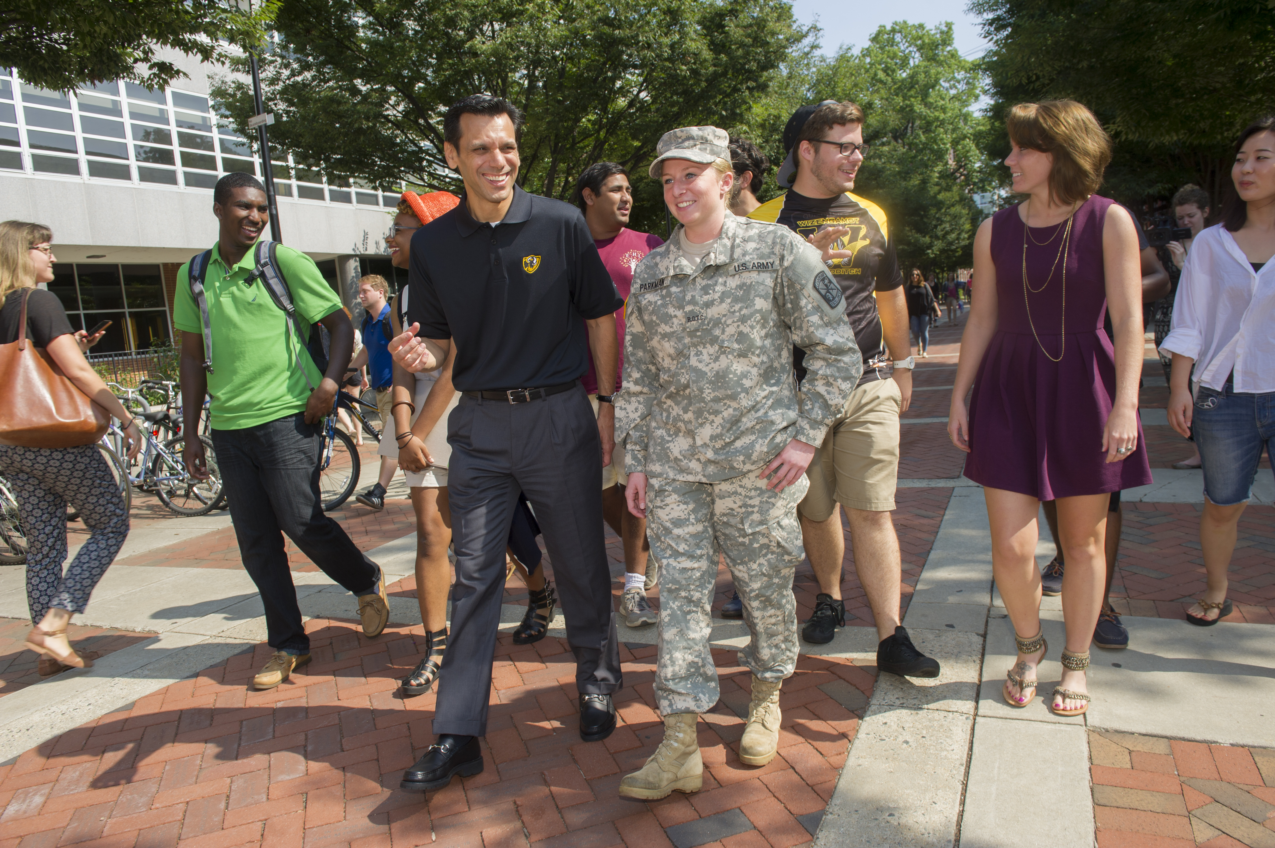 VCU President Michael Rao, Ph.D., walks with military student on campus