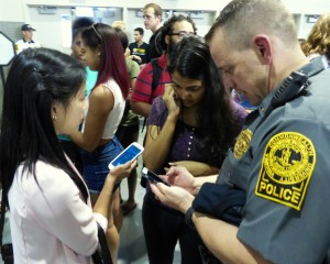 VCU Police Lt. Bill Butters assists students at VCU's SOVO Fair at the Siegel Center.
