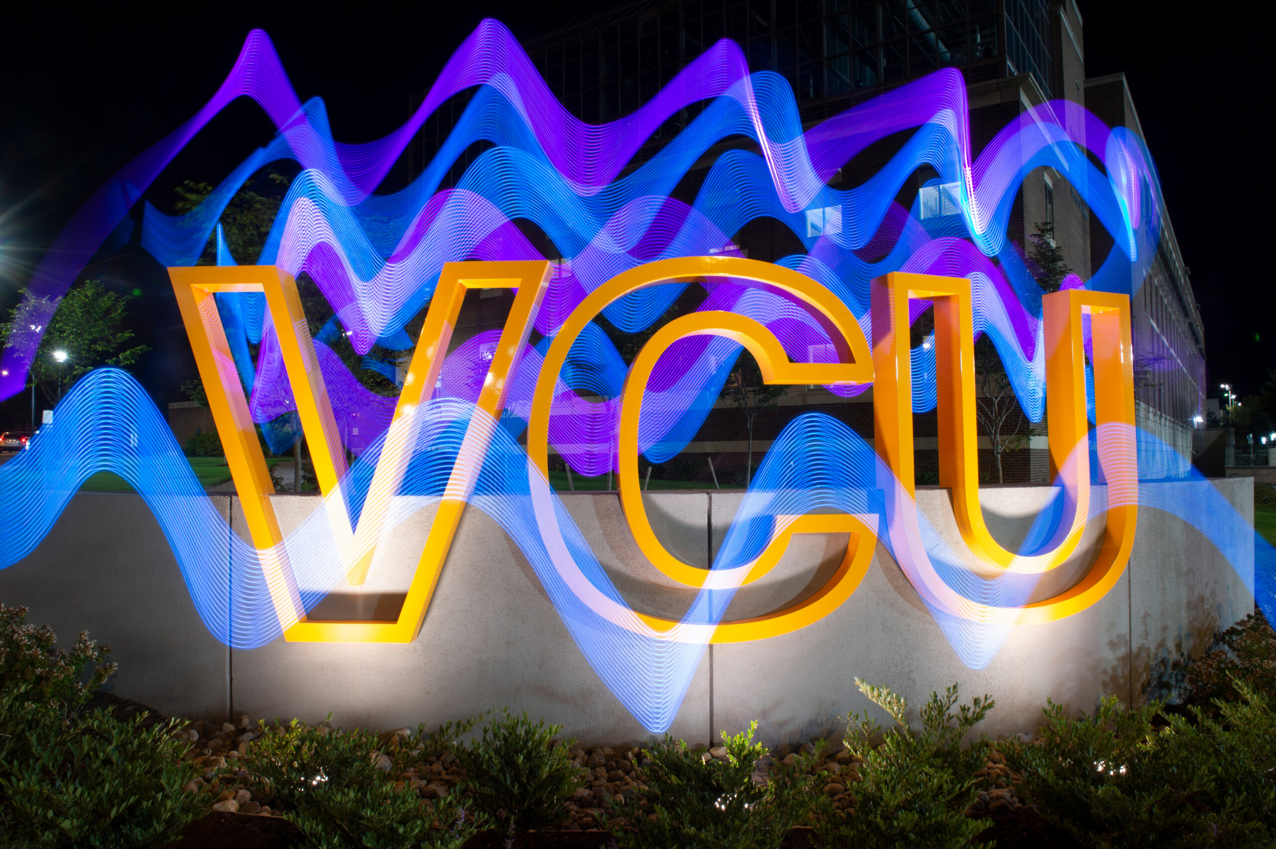 VCU sign with abstract light squiggles