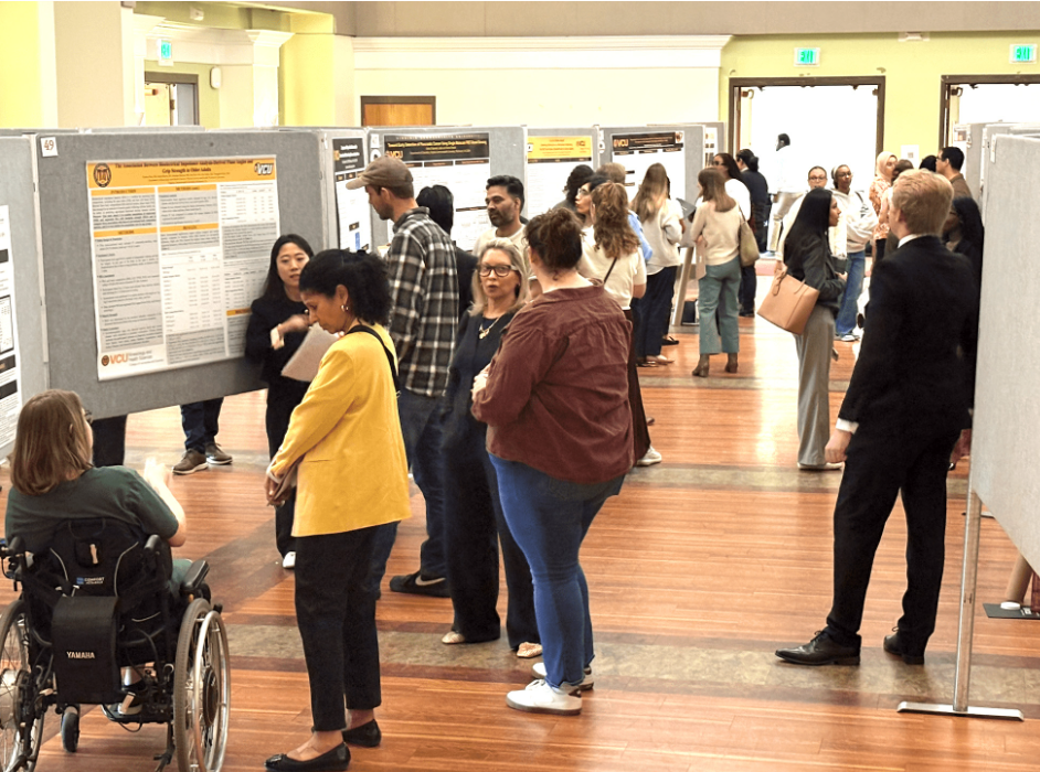 Graduate students answer questions about their research posters