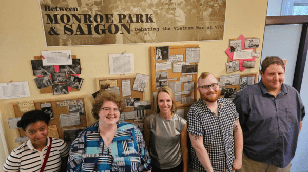 students who worked on project in front of display