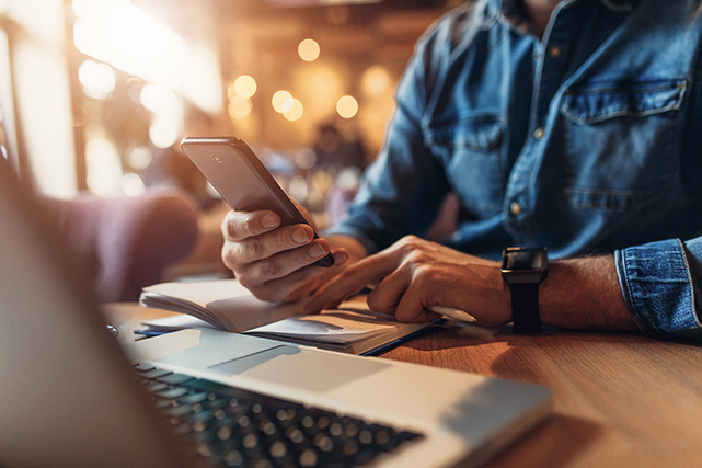 Image of a man holding a phone.