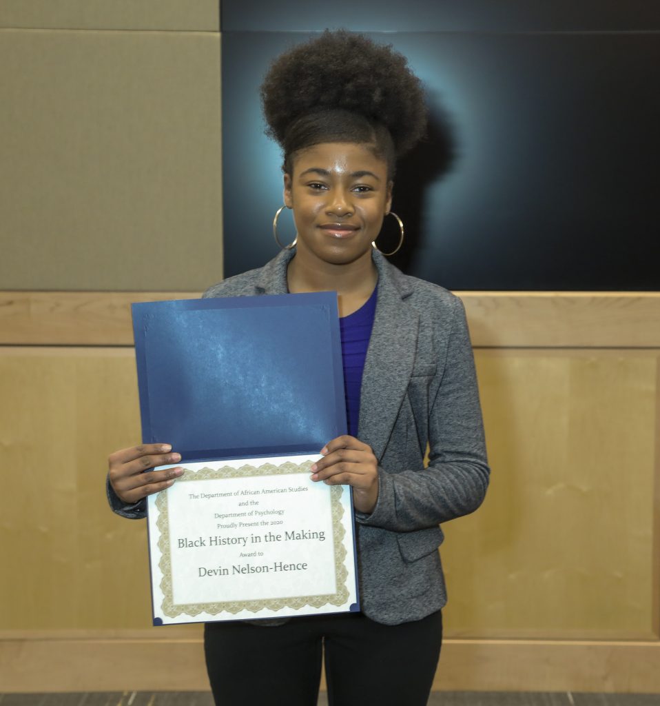 Devin Nelson-Hence, an undergraduate researcher in social work, holding her Black History in the Making certificate