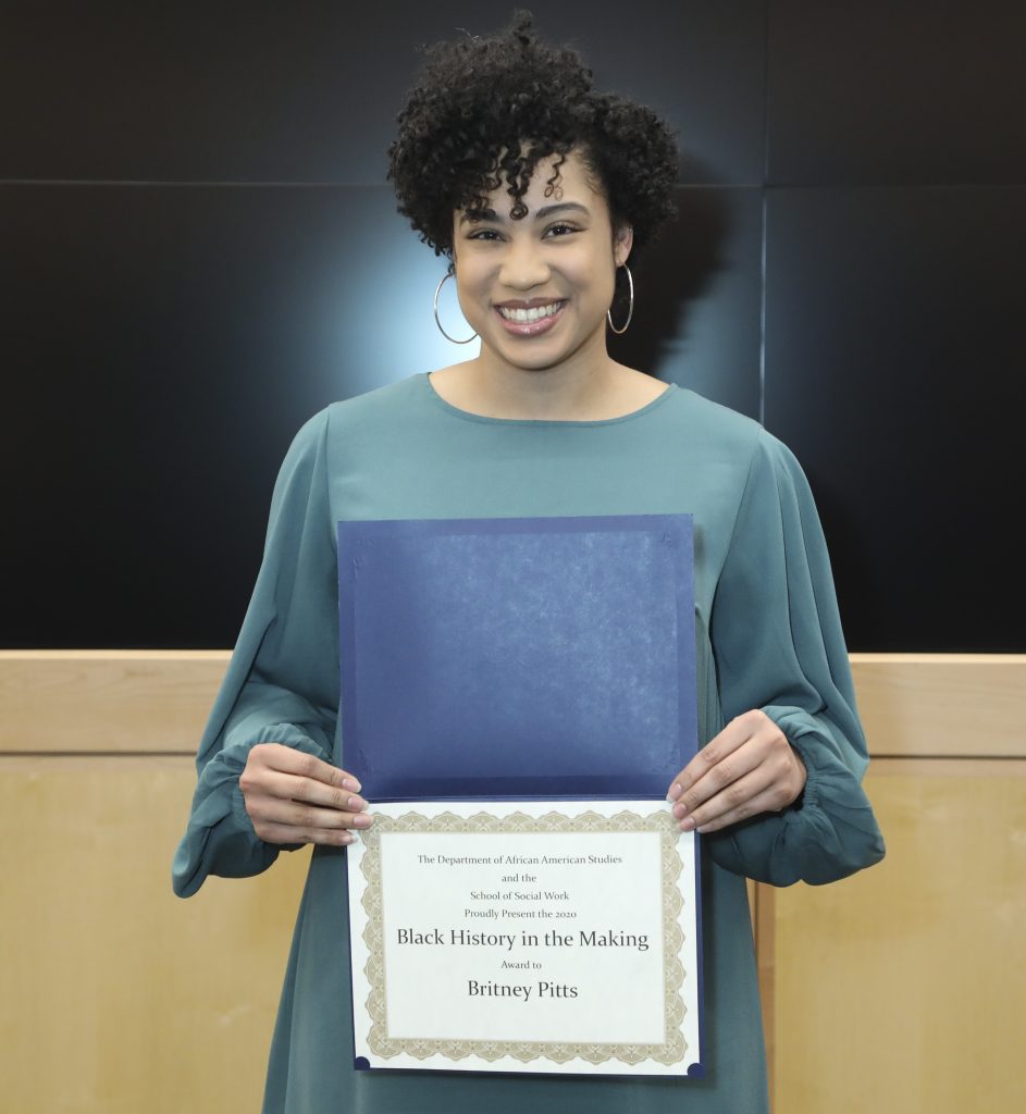 Britney Pitts, P-H-D student, holding her Black History in the Making certificate