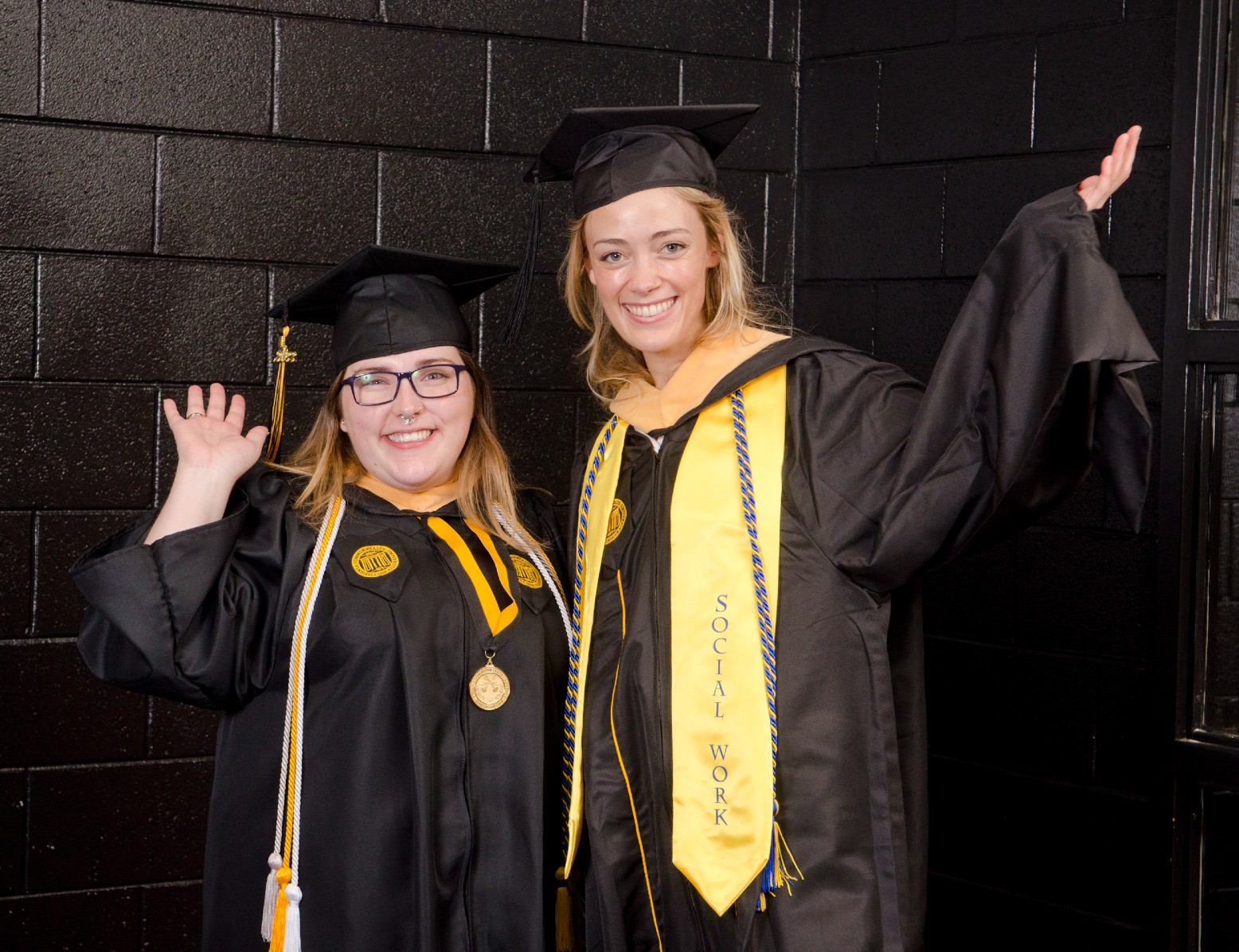 Summer D. Jones, a B.S.W. graduate, and Summer C. Jones, an M.S.W. graduate pose together, waving, before the 2022 Commencement ceremony.