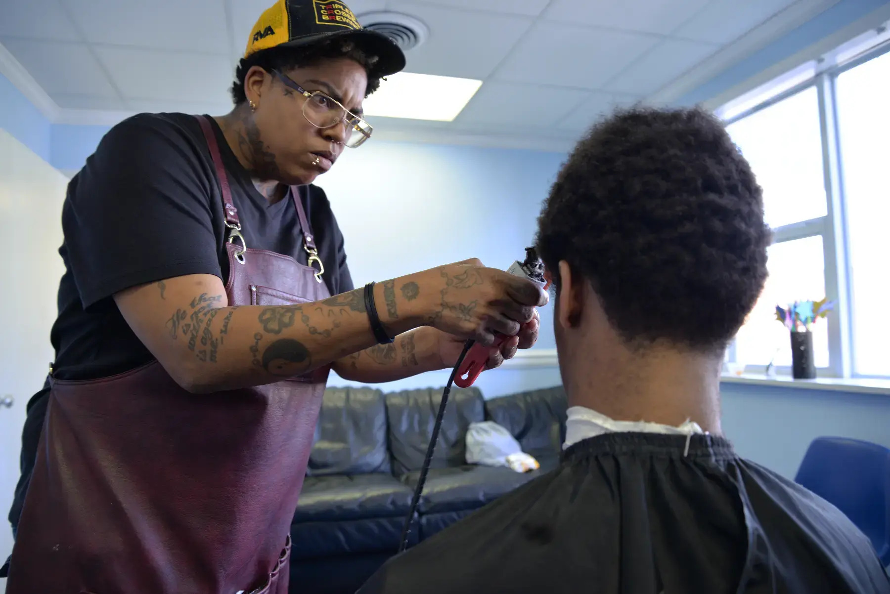 Dot Reid, owner of Refuge for Men, provided free haircuts to youth facing homelessness or unstable housing at the pop-up drop-in center at Side By Side.
