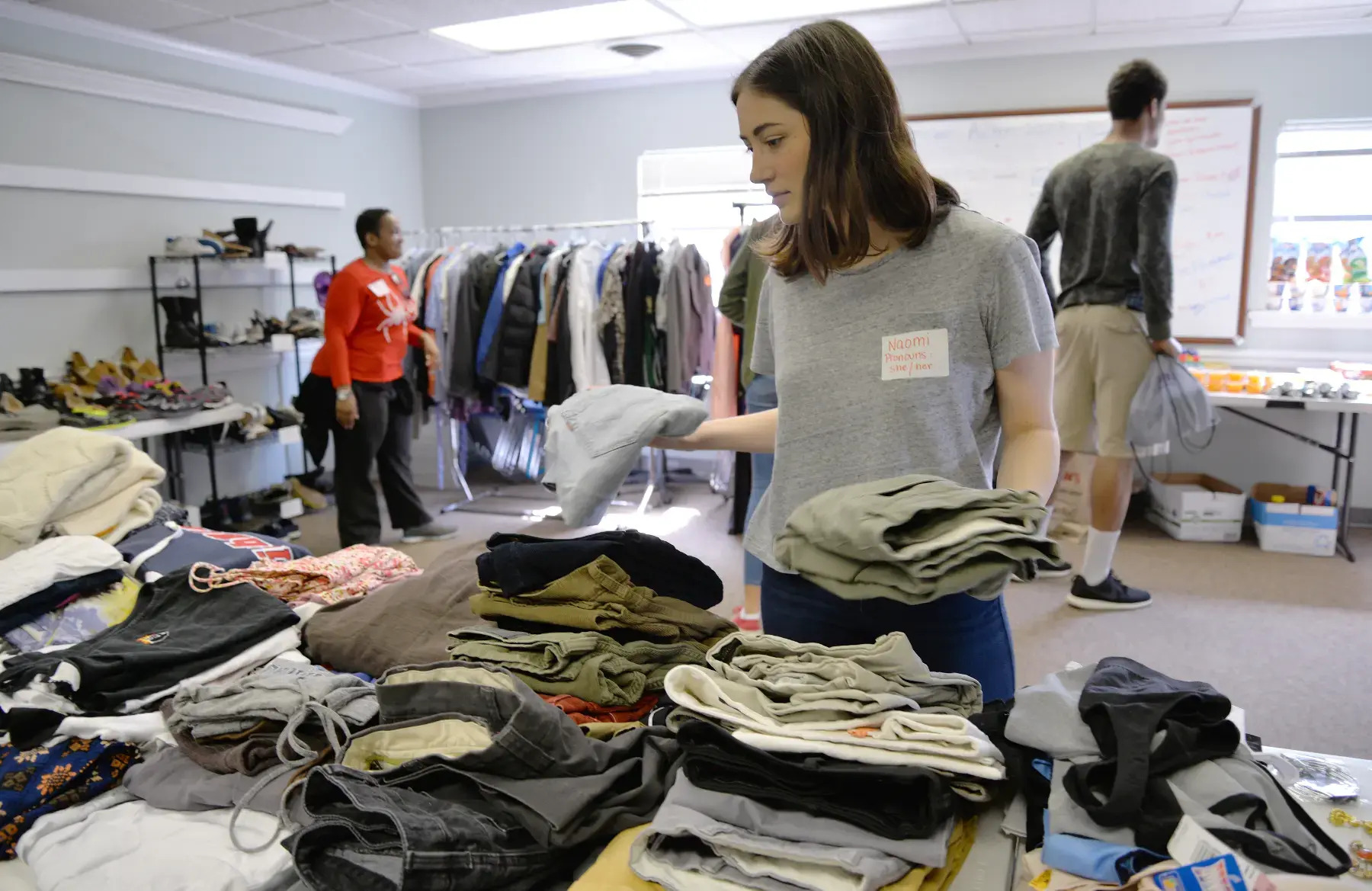 Naomi Sand, a University of Richmond student, volunteered at the pop-up drop-in center through UR's WILL* program, helping to sort and fold clothing donations for youth facing homelessness and unstable housing.