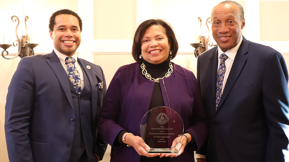 VCU social work alum Viola Vaughan-Eden holds a glass award from the Congressional Research Institute for Social Work and Policy; standing next to her are CRISP officials Justin Hodge, academic director, and Charles Lewis, director.