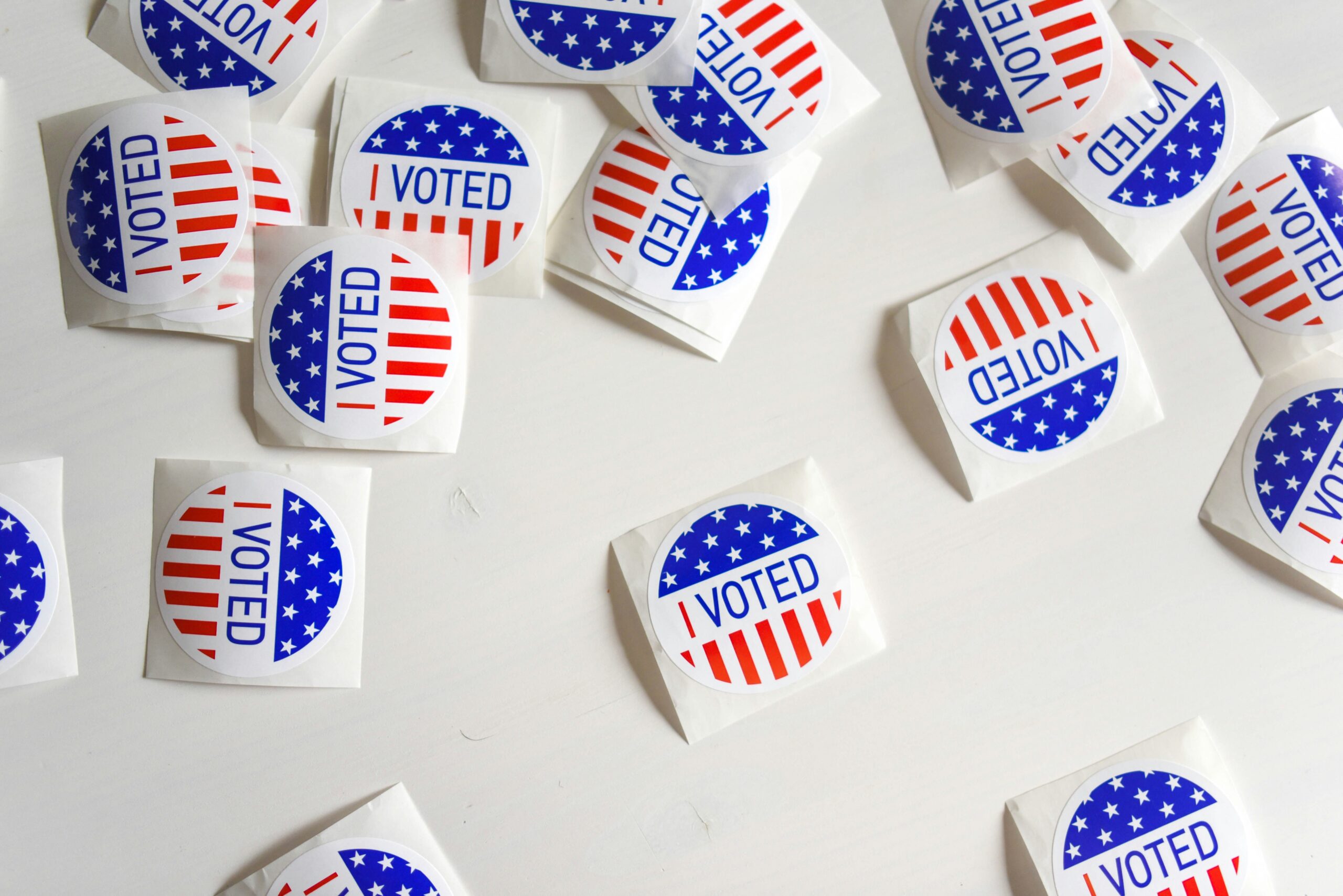 many I Voted stickers laid out on a table