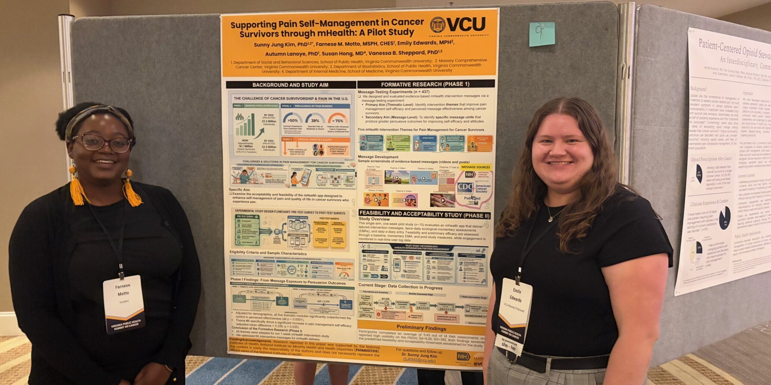 two students stand smiling in front of a poster board featuring their research